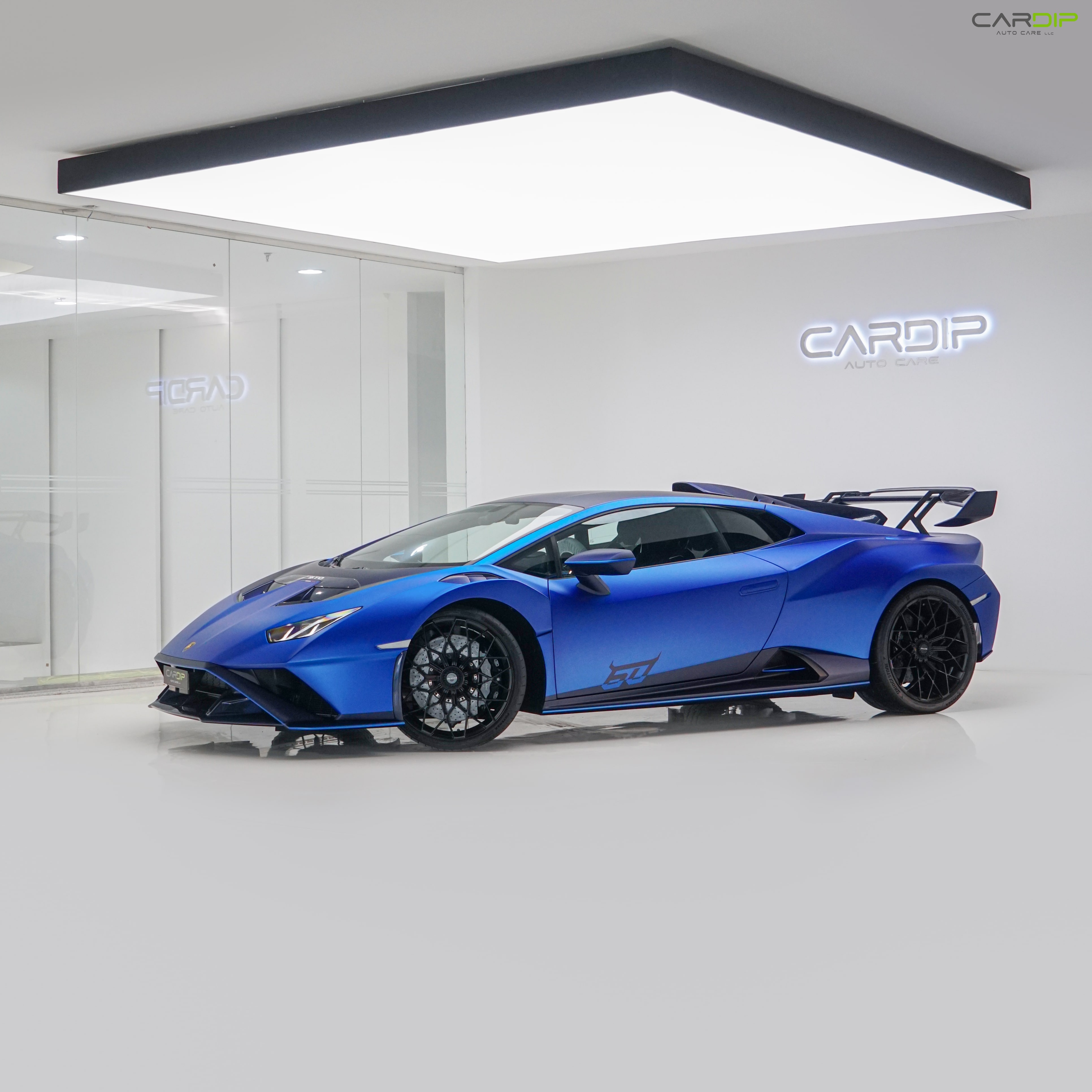 Technician reupholstering a luxury car seat using premium leather in a Dubai workshop